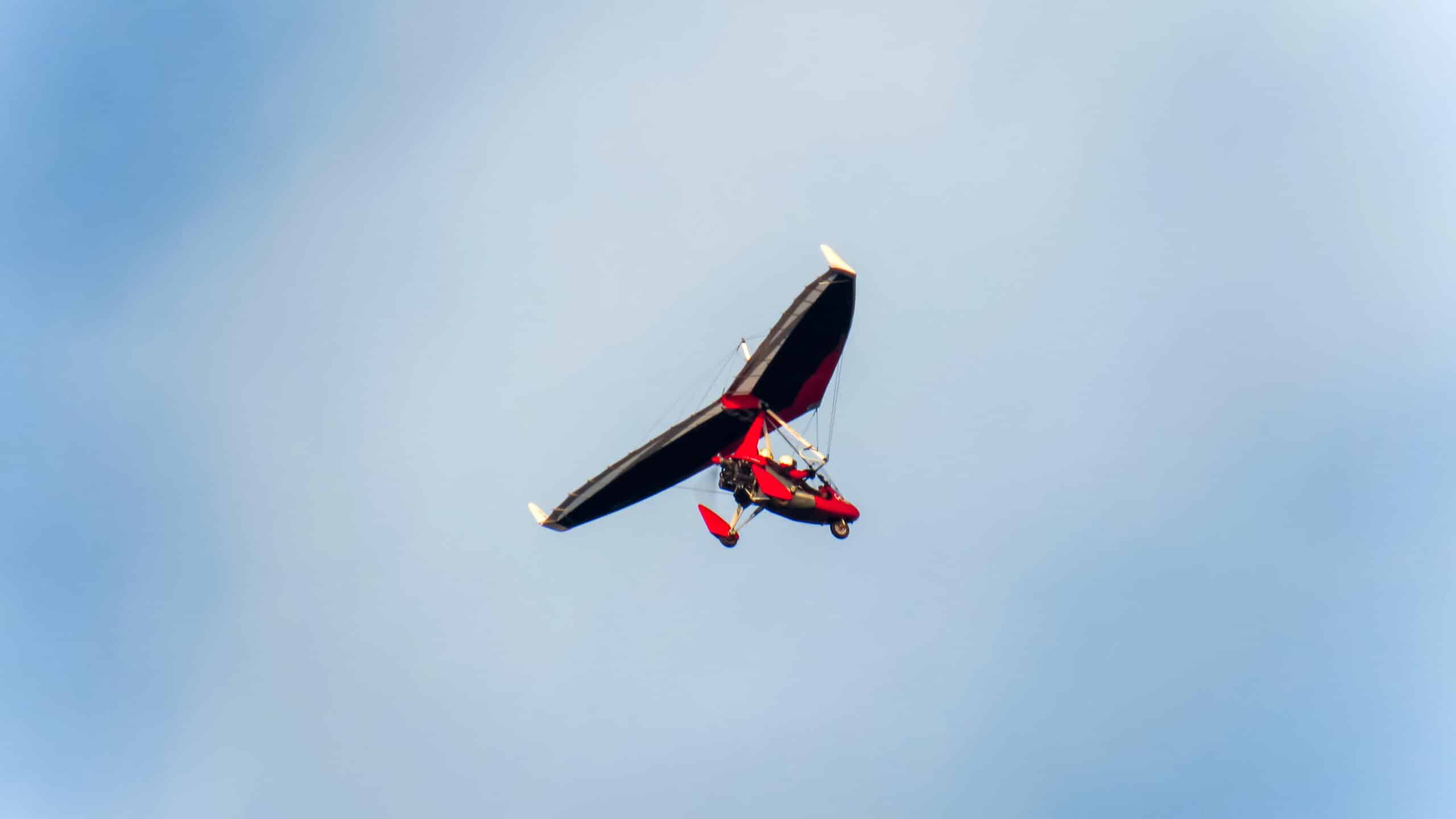 Man flying in motorized hang glider in Liverpool, United Kingdom